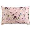 A square silk pillowcase with a pale pink background featuring a purple and green floral print.