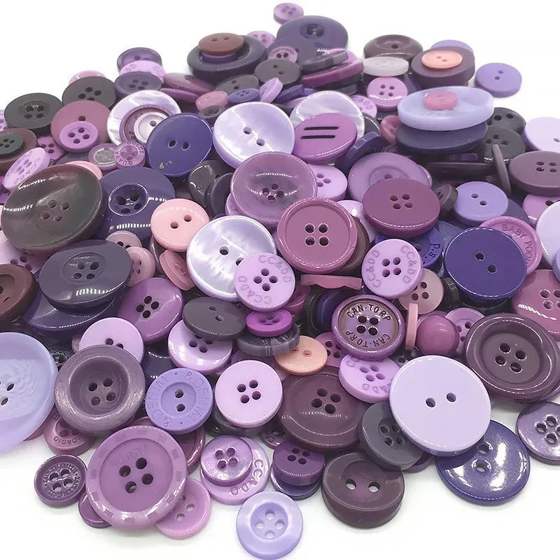 A collection of various sized wooden buttons in shades of purple and pink for scrapbooking
