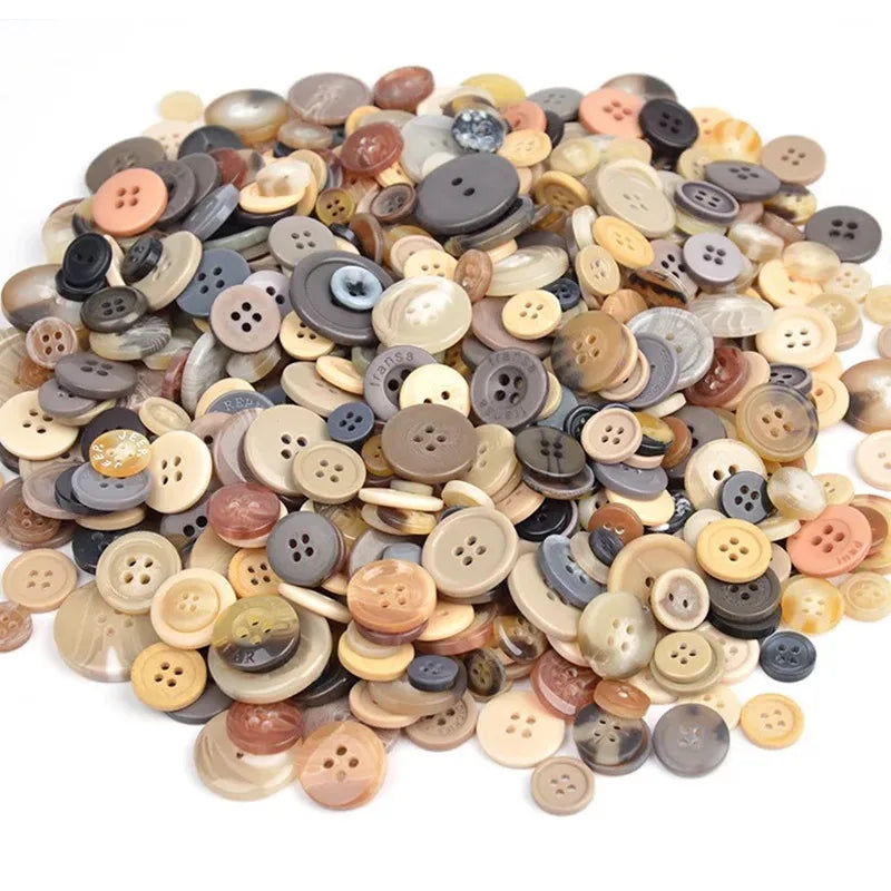A pile of mixed size wooden buttons in various natural and muted earth tones for scrapbooking
