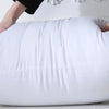 A white extra-long body pillow being held by hands, demonstrating its full-body support.