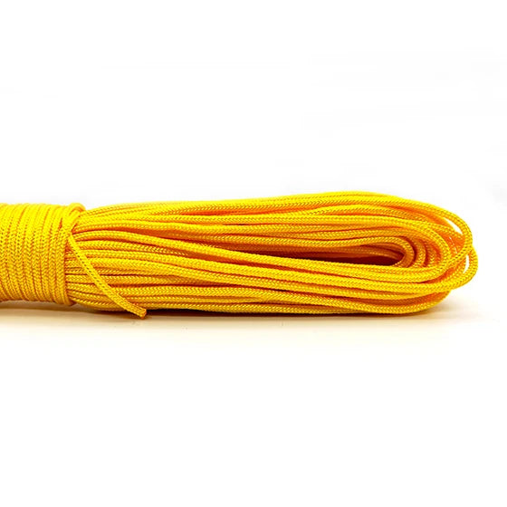 A coil of bright yellow paracord rope is laid horizontally against a white background.