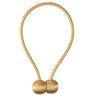 A gold-colored magnetic pearl ball curtain tieback with a thin cord.