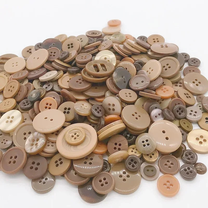 A collection of various sized wooden buttons in natural and earth tones for scrapbooking