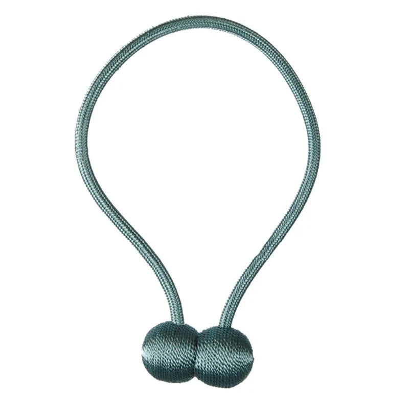 A silver-green magnetic pearl ball curtain tieback with a thin cord.