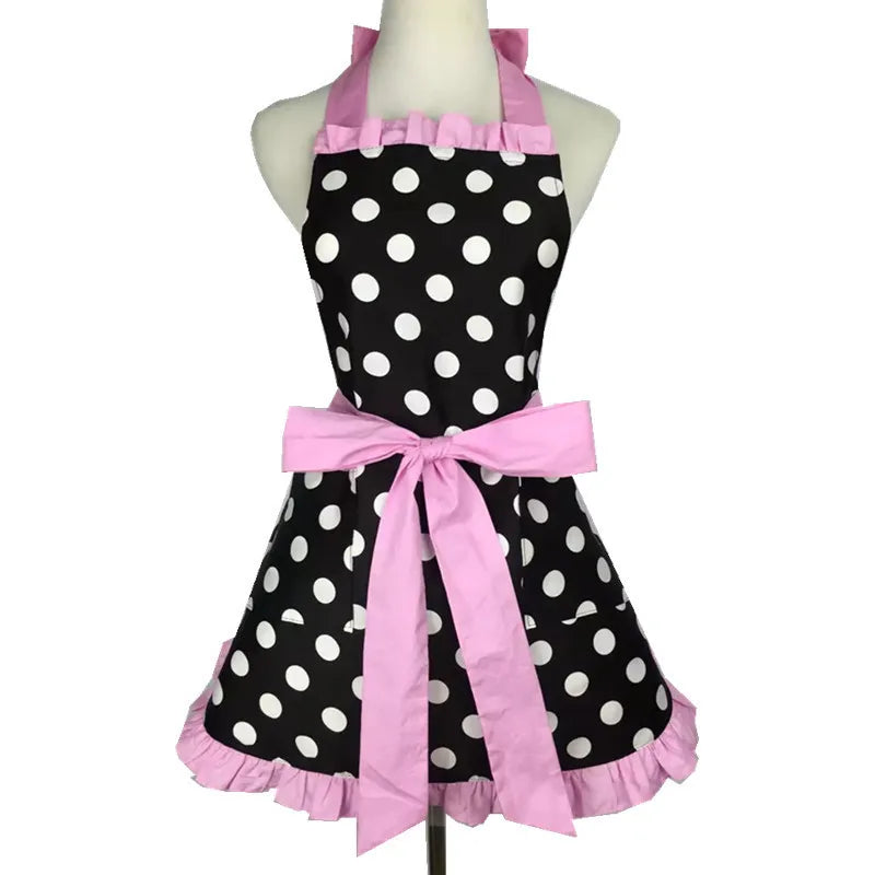 A pink polka dot ruffle apron with pockets displayed on a mannequin.
