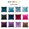 A grid display of 22 solid velvet decorative cushion covers in various shades of blue, green, purple, pink, and brown.