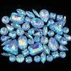 A collection of sparkling blue and white silver claw rhinestones arranged in a circular pattern.