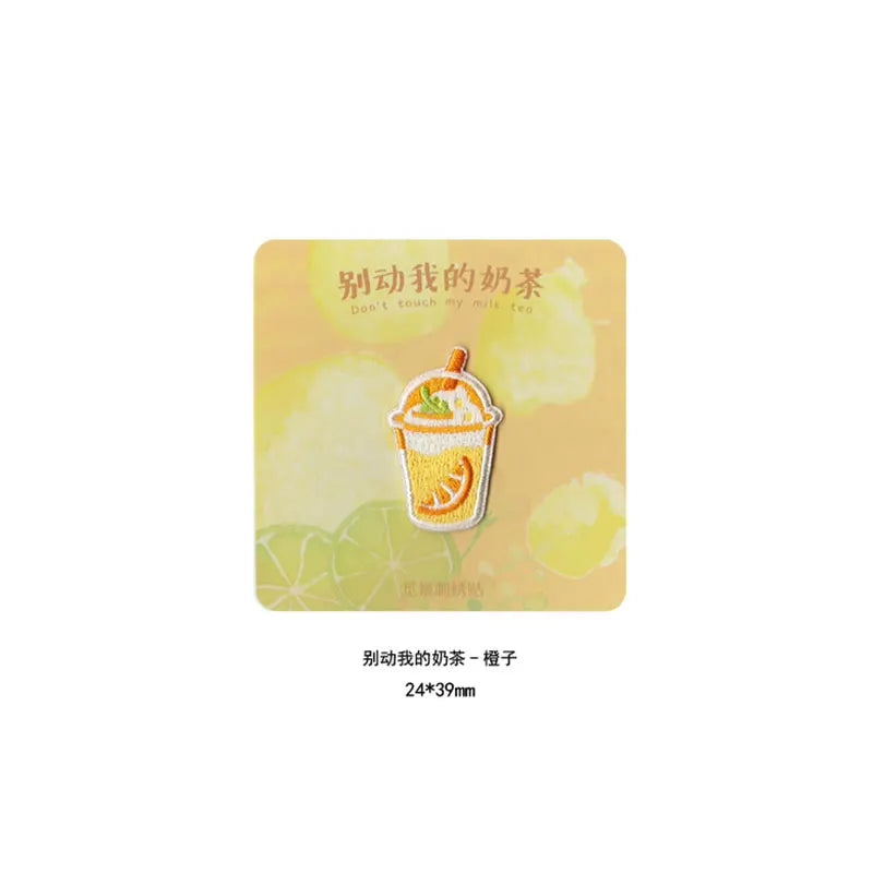 An embroidered patch featuring a yellow iced tea drink design on a light yellow background.