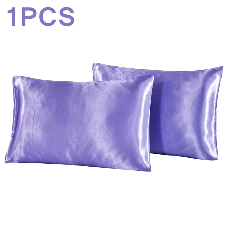 One silky purple satin pillowcase shown next to another one.