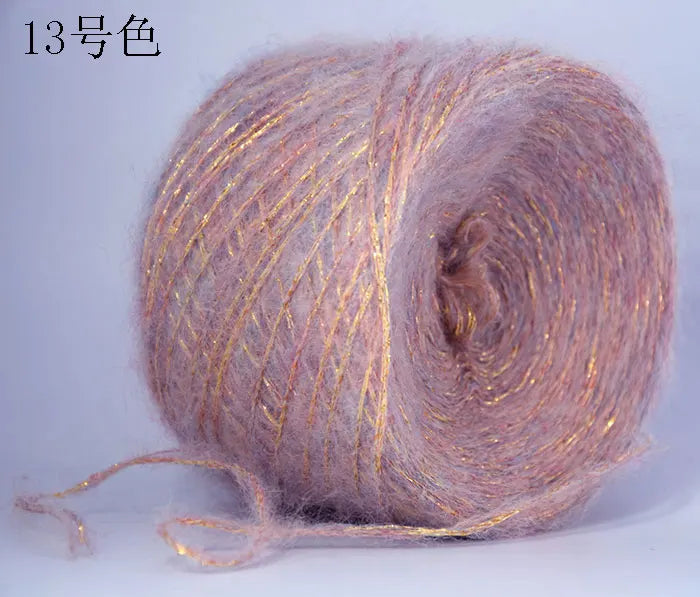 A ball of metallic pink merino wool yarn used for hand knitting.