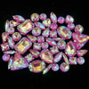 A collection of pink and purple faceted rhinestones arranged in a decorative pattern.