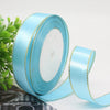 Rolls of light blue satin ribbon with gold edges for gift wrapping and crafts