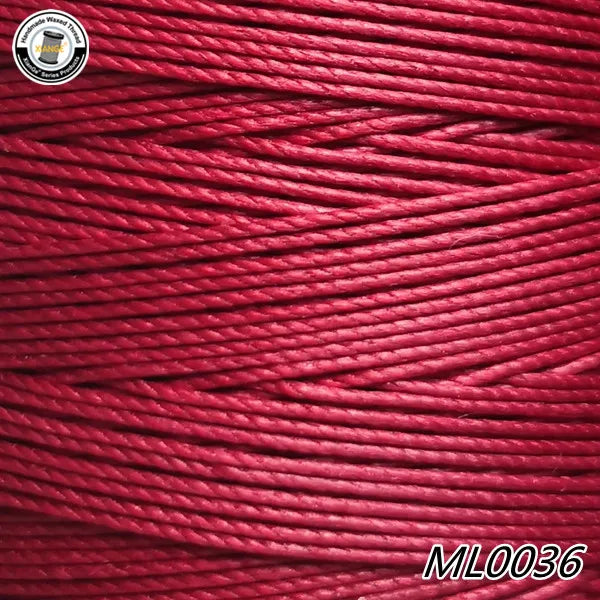 A close-up view of red embroidery thread or cord coiled on a spool.