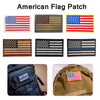A collection of embroidered American flag patches in various designs and colors.