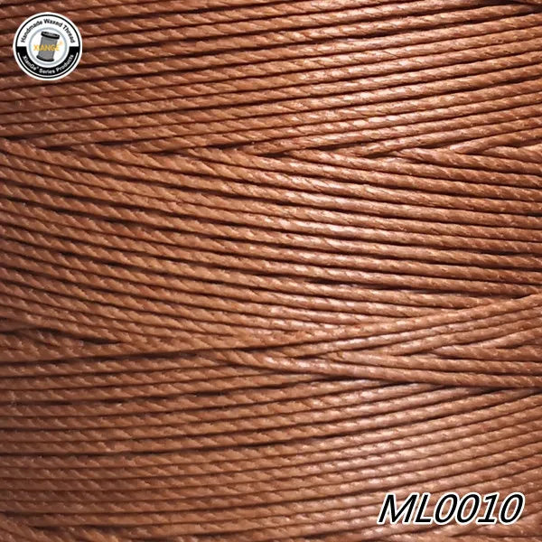 A spool of brown waxed thread embroidery cord is shown in a close-up view.