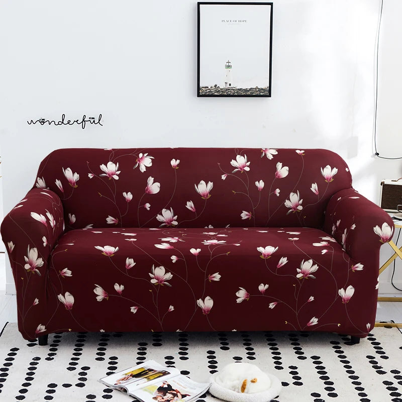 A deep burgundy stretch floral elastic sofa cover featuring pink and white flowers on a white rug.