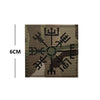 Embroidered Valknut Viking patch with hook and loop backing on a fabric background.