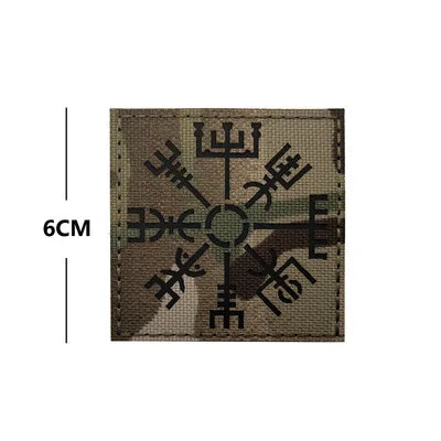 Embroidered Valknut Viking patch with hook and loop backing on a fabric background.