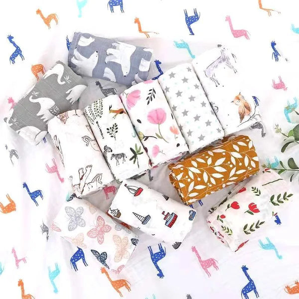 A collection of patterned muslin swaddle blankets featuring various animal designs and floral prints.