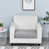 A white armchair with a gray seat cushion cover sits against a light blue wall.