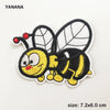 A black and yellow embroidered bee patch featuring wings and a face on a white background.
