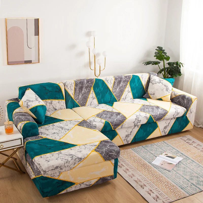 A stylish printed sofa protector cover in teal, gray, and yellow geometric pattern on a sofa.