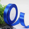 Roll of royal blue satin ribbon with a gold edge for gift wrapping and crafts