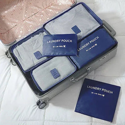 A gray and blue 6-piece laundry pouch organizer set with a pink fabric bag visible in the background.