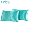 One silky teal satin pillowcase shown in a folded or laid-out form.