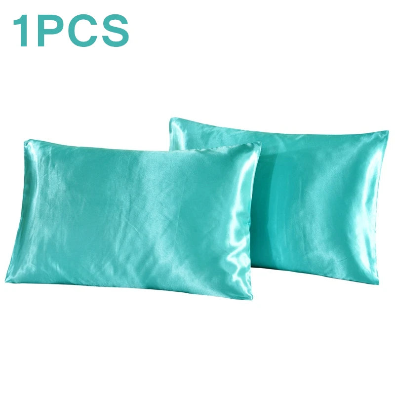 One silky teal satin pillowcase shown in a folded or laid-out form.