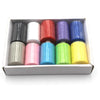 A box containing ten colorful polyester sewing thread spools in various shades of black, white, red, purple, blue, and yellow