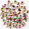 A collection of silver claw rhinestone decorations in various shades of pink and green.