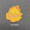Yellow and pink embroidered iron-on patch featuring a stylized, spiky character face.