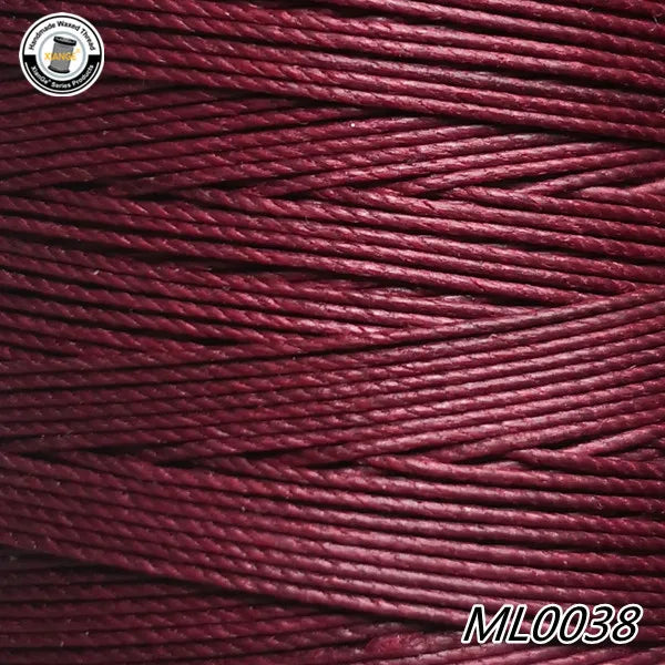 A spool of deep maroon waxed thread embroidery cord with a white logo visible in the top left corner.