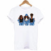 White t-shirt featuring a graphic design of three women with curly hair and sunglasses