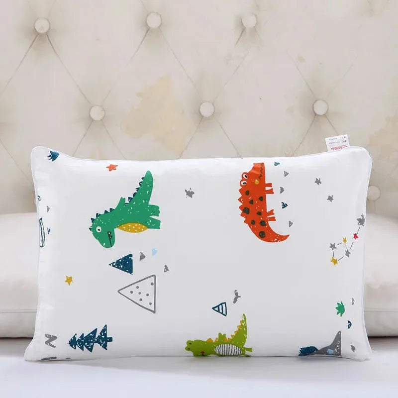 A white cartoon style children's pillowcase featuring various colorful animal and geometric shapes.