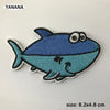 A blue embroidered animal patch of a fish with large eyes
