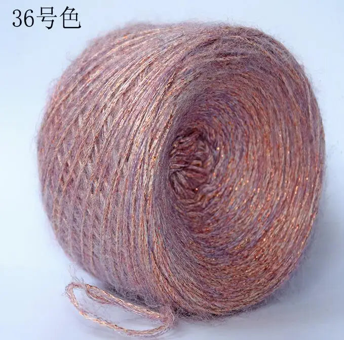 A spool of metallic pink merino wool yarn for hand knitting