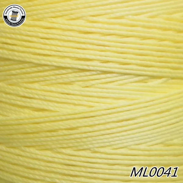 A spool of bright yellow waxed thread embroidery cord is shown in a close-up view.