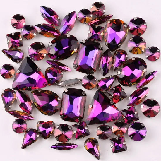 A collection of 50 silver claw rhinestone decorations in various shades of purple and pink.