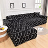 Black and white geometric patterned L-shape sofa protector covers displayed on a wooden floor.