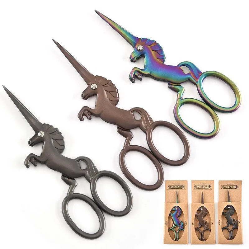 A set of three stainless steel unicorn sewing scissors in various colors and finishes.