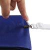 A hand is using a metal fastener to open a blue fabric pouch or bag.