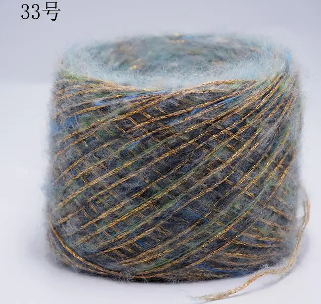 A ball of metallic gray and blue merino wool yarn for hand knitting