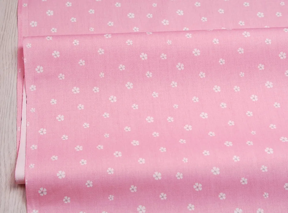 Pink floral and stripe cotton twill fabric rolled for sewing and DIY projects