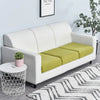 A white sofa with a lime green seat cushion cover and a potted plant in a modern living room setting.