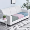 A white sofa is adorned with colorful fleece seat cushion covers in shades of blue, pink, and green.