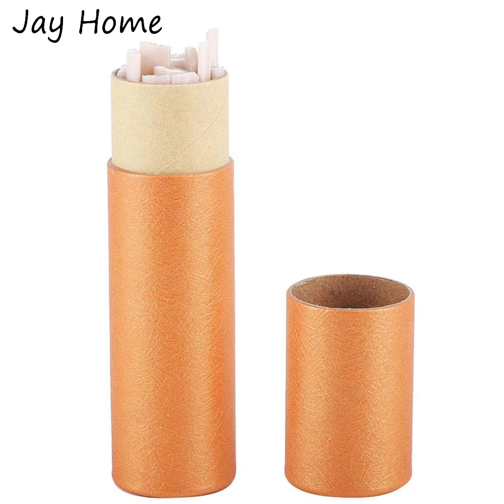 A set of fabric marking chalk pens in orange and beige colors, packaged in cardboard tubes.