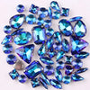 A set of 50 silver claw rhinestone decorations featuring various shades of blue and teal gemstones.