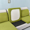 A lime green stretch sofa seat cushion protector slipcover with a white interior and black pad.